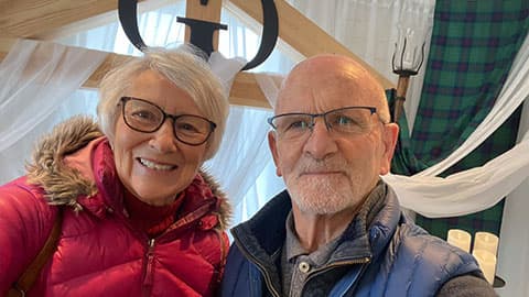 Bryan with his wife at a Loughborough University event. They are standing together and smiling.